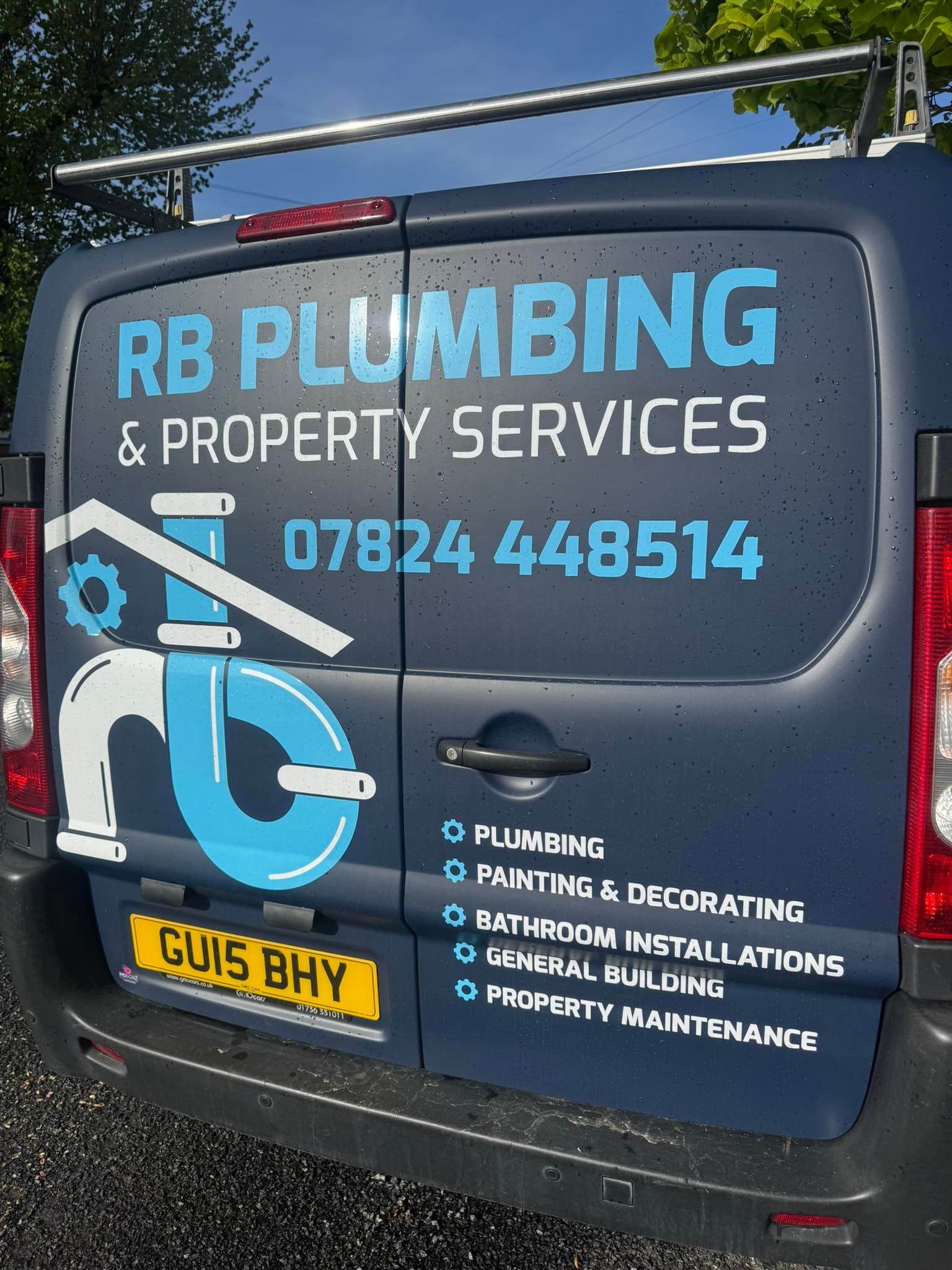 RB Plumbing & Property Services branded work van — phone 07824 448514 painted on the rear door alongside the services list.